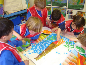 Bearwood College Reception Class making a mosaic of the Olympic Torch 